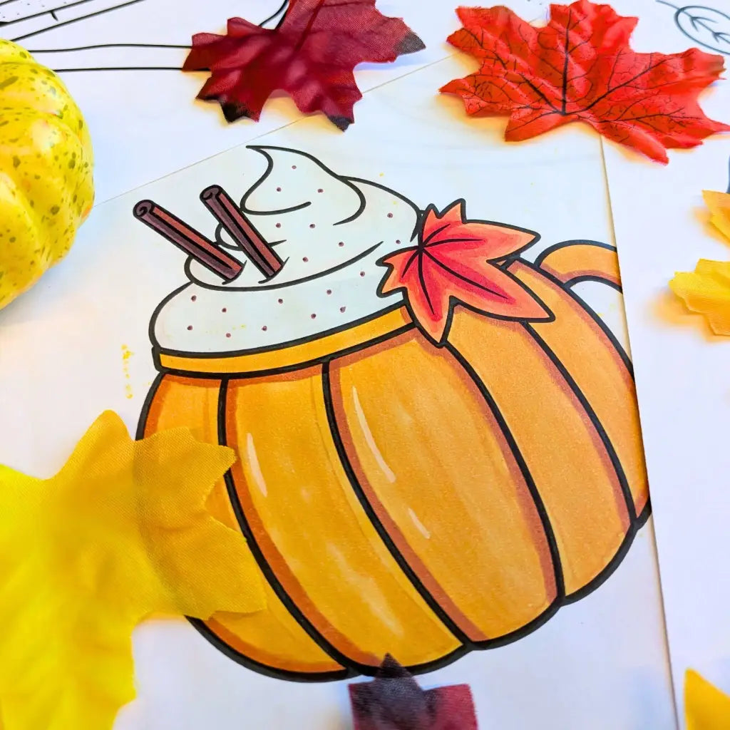 Completed coloring book page with a cozy pumpkin mug and cinnamon-sprinkled whipped cream, surrounded by autumn leaves and a small heirloom pumpkin.