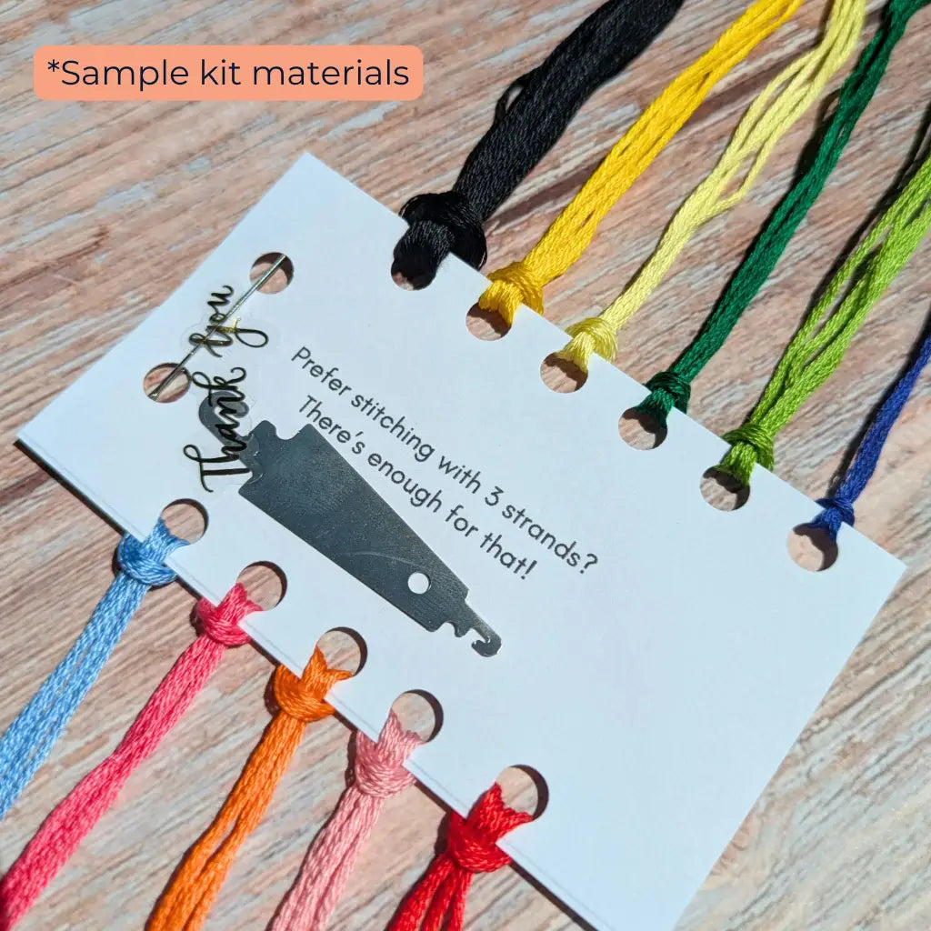Colorful string samples on a card with text on a wooden surface